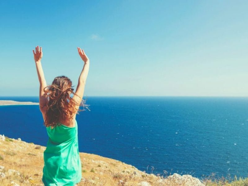 Happy lady looking at ocean